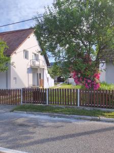 a wooden fence in front of a white house at Veranda in Saborsko
