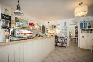 a large kitchen with a counter and a counter at Piccolo Hotel Kursaal in Cesenatico
