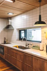 a kitchen with a sink and a window at Stay JungEui in Seogwipo