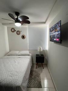 a bedroom with a bed and a ceiling fan at Modern Condo in Ecovivienda in Tegucigalpa