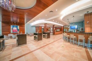 a lobby of a hospital with tables and chairs at Calimera Ralitsa Superior Hotel - Ultra All Inclusive plus Aquapark in Albena