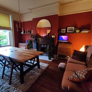 a living room with a wooden table and a couch at Merchant House in Bootle