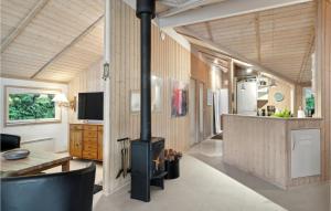 - un salon avec un poêle à bois dans une maison dans l'établissement Stunning Home In Dronningmlle With Kitchen, à Dronningmølle