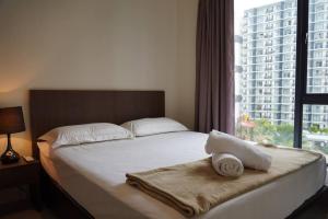 Ένα ή περισσότερα κρεβάτια σε δωμάτιο στο Kuantan Getaway Waterpark and Beach +14 φωτογραφίες
