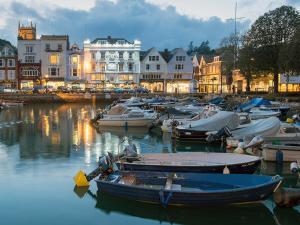 a group of boats docked in a harbor with buildings at Driftwood in Dartmouth