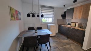 a kitchen with a table and chairs in a kitchen at QR Apartment for Family, Couples, and Friends stay in Rijeka in Rijeka