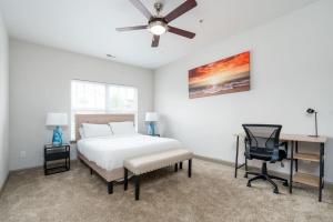 a bedroom with a bed and a desk and a chair at Lovely 1-Bedroom Keystone in Indianapolis