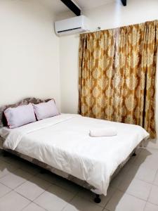 a bedroom with a white bed with a curtain at Mohans Apartments in Nausori