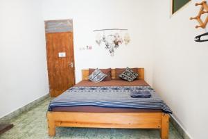 a bedroom with a wooden bed in a room at Good Karma Yogyakarta in Yogyakarta