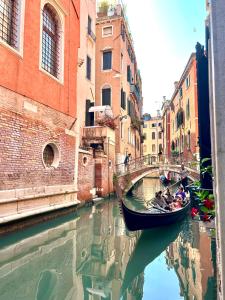 a group of people in a gondola on a canal at Hotel Alcyone in Venice