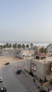 a parking lot next to the beach with cars parked at Fully Furnished 2bedroom apartment, Salalah, Oman in Salalah