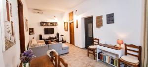 a living room with a couch and a table at House on Sea Sifnos in Cherronisos