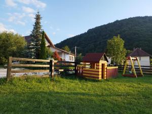 a yard with a fence and a playground at Vila Alisa in Bran