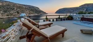 a patio with chairs and a view of the ocean at House on Sea Sifnos in Cherronisos