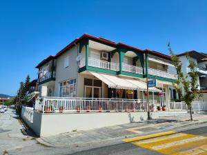 a building on the corner of a street at PhiloxenInn in Polygryos +17 photos