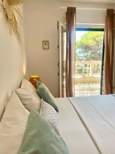 a bedroom with a bed with pillows and a window at Villa Mira in Bol