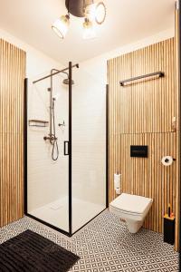 a bathroom with a shower and a toilet at Apartament Incognito Rynek in Tarnobrzeg +24 photos