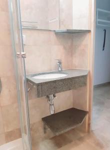 a bathroom with a sink and a mirror at Apartamenty Rodzinne Pilica PARK in Sulejów