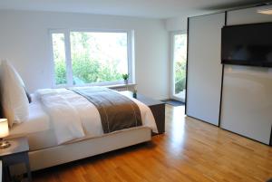 a bedroom with a bed and a large window at FeWo-Hochblauen in Badenweiler