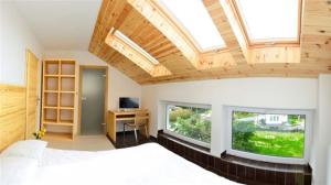 a bedroom with a bed and a window and a desk at KOMPAS in Jastrzębia Góra +18 photos