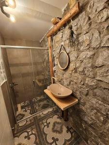 a stone bathroom with a sink and a shower at Chateau Orman 