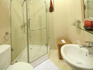a bathroom with a shower and a toilet and a sink at Rising Dragon Hotel in Hanoi