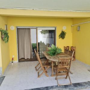 a wooden table and chairs on a patio at Kubata Hill in Parede