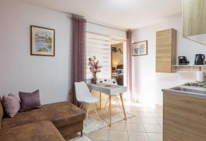 a living room with a couch and a table at Bougainvillea--Apartment By The Sea in Ston