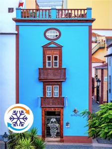 a blue building with a clock on top of it at Suites Plaza Vandale in Santa Cruz de la Palma