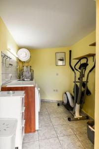 a room with a gym with a treadmill and a sink at Villa Nona in Acharavi