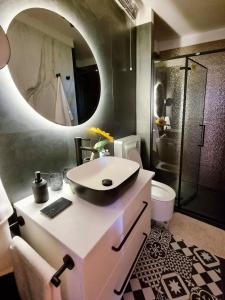 a bathroom with a sink and a mirror at Apartment Sol Dolcevita in Njivice +41 photos