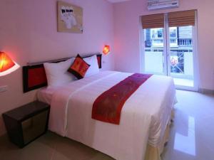 a bedroom with a large white bed and a window at Rising Dragon Hotel in Hanoi