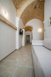 a room with a bed and a tile floor at CASA ALEF in Manduria