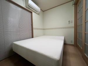 Postel nebo postele na pokoji v ubytování PLATINUM kitaoji