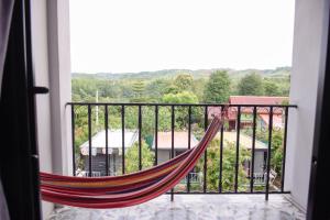 a hammock on a balcony with a view at นอน นี่ นะ โฮสเทล Noen nee Na Hostel in Ban Non Na Yao