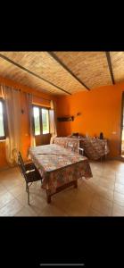 a room with two beds and two tables in it at La massaria di Cesare in Pianella