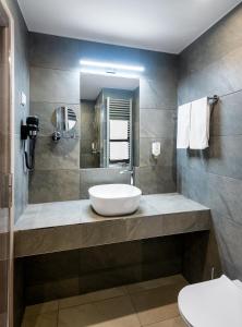 a bathroom with a sink and a toilet at Hunguest Helios Hévíz in Hévíz