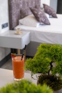 a drink sitting on a table next to a bed at Avion Suite Hotel in Antalya