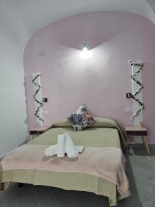 a bedroom with a bed with two towels on it at Hostal Pompeya Merida in Merida