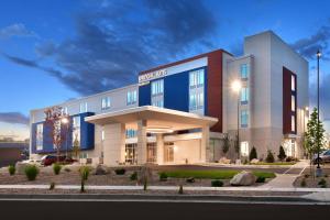 a hotel building with a blue and white at SpringHill Suites by Marriott Salt Lake City-South Jordan in South Jordan