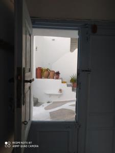 an open door with potted plants in a room at Aiolos TRADITIONAL HOUSE IN ASTYPALAIA in Astypalaia