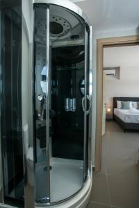 a glass shower in a room with a bedroom at Villa Aurora in Faliraki