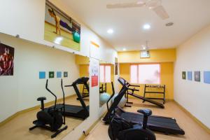 a gym with cardio equipment in a room at Ginger Mysore in Mysore