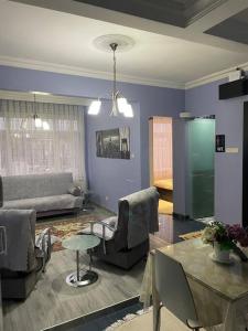 ein Wohnzimmer mit einem Sofa, Stühlen und einem Tisch in der Unterkunft İstanbul’un Merkezi in Istanbul