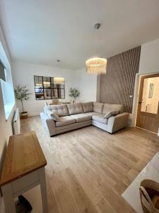 a living room with a couch and a table at Coastal Apartments No 1 in Seaham