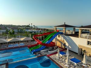 a water slide in a pool at a resort at Orange County Belek in Belek +104 photos