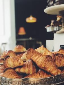 a tray of croissants and pastries on a table at F9 Hotels 343 Meera Bagh, Paschim Vihar in New Delhi