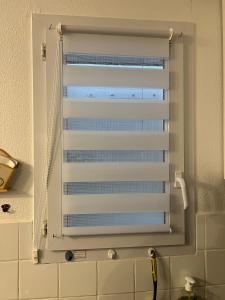 a window with a white shutter in a bathroom at Les Amareyeurs - Ile d'Oléron - Maison classée 3 étoiles avec piscine - Clim - Vélos in Le Château-dʼOléron