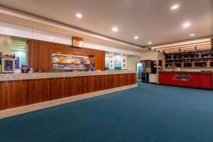 a fast food restaurant with a counter and a bar at Orange County Belek in Belek