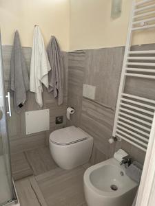 a small bathroom with a toilet and a sink at Corte Paradiso in Turin